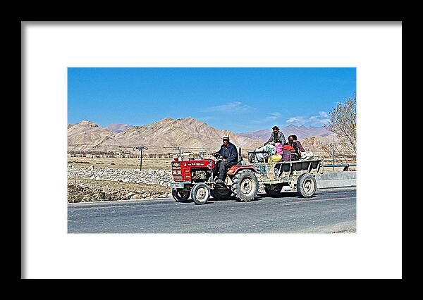 Tractor Towing A Wagon Along The Road To Shigatse Framed Print featuring the photograph Tractor Towing a Wagon along the Road to Shigatse-Tibet by Ruth Hager