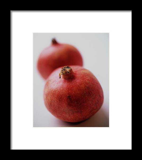 Fruits Framed Print featuring the photograph Two Pomegranates by Romulo Yanes