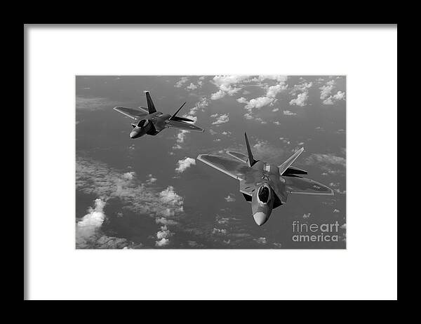 Guam Framed Print featuring the photograph U.S. Air Force F-22 Raptors in flight near Guam. by Stocktrek Images