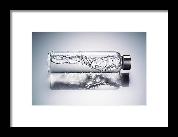 Headwear Framed Print featuring the photograph Water Wave in Glass Bottle by MirageC