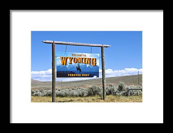 Welcome Framed Print featuring the photograph Welcome To Wyoming Sign by Bill Bachmann