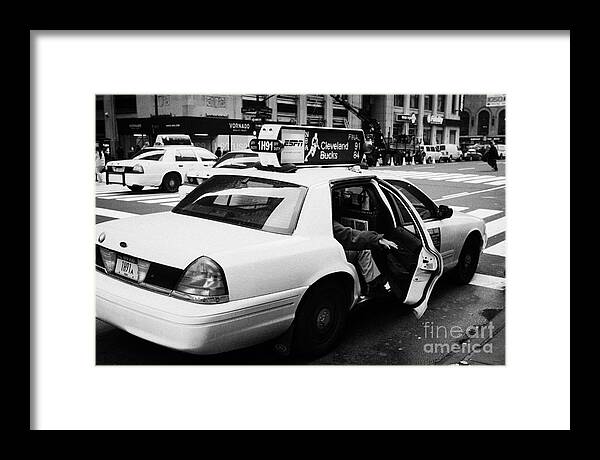 Usa Framed Print featuring the photograph white caucasian passenger closes rear door of yellow cab on taxi rank at crosswalk on 7th Avenue by Joe Fox