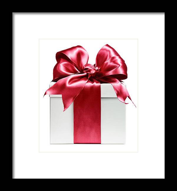 White Background Framed Print featuring the photograph White gift wrapped in red bow by Lauren Burke