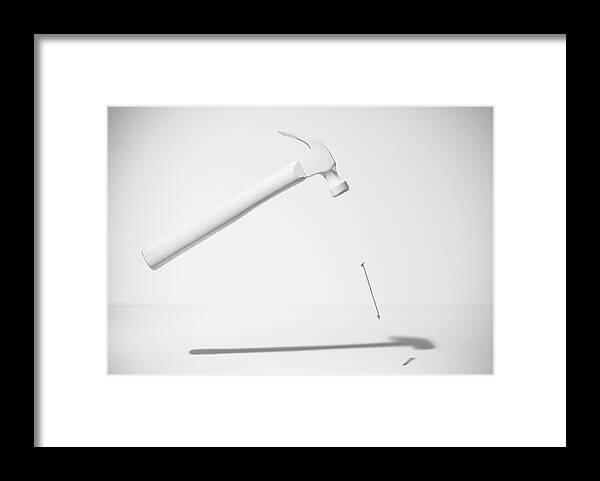 Shadow Framed Print featuring the photograph White Hammer And Nail Levitating by Pm Images