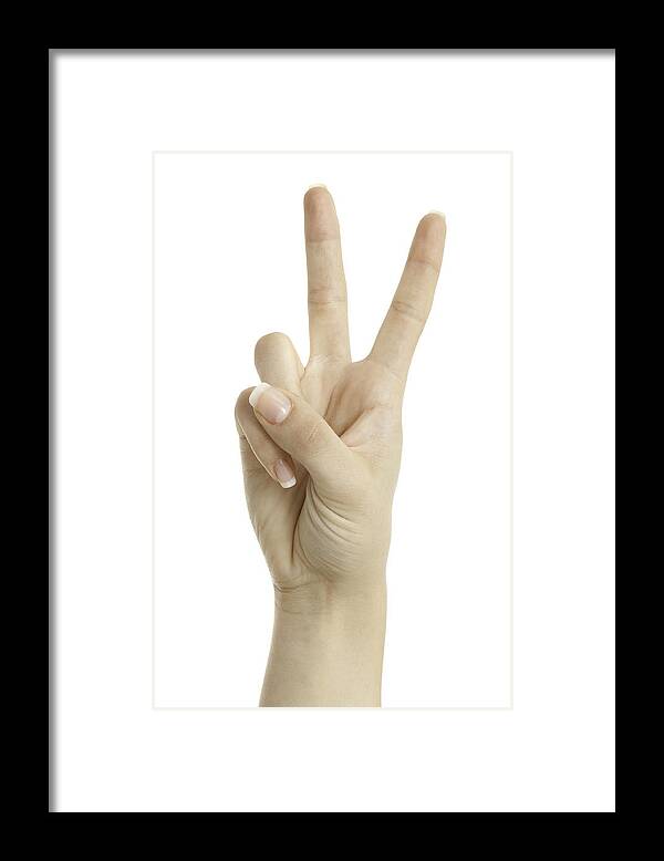 Thumb Framed Print featuring the photograph Woman hand showing peace sign isolated on white background by Deepblue4you
