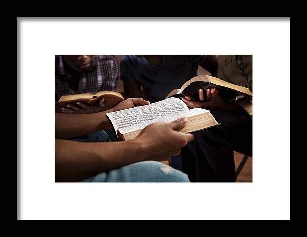 Information Medium Framed Print featuring the photograph Young adults in a Bible study. by Fstop123