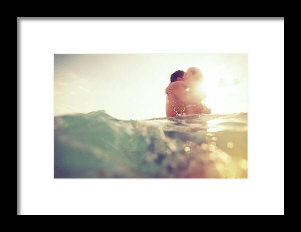 Young Men Framed Print featuring the photograph Young Couple Having Fun In The Sea by Nullplus