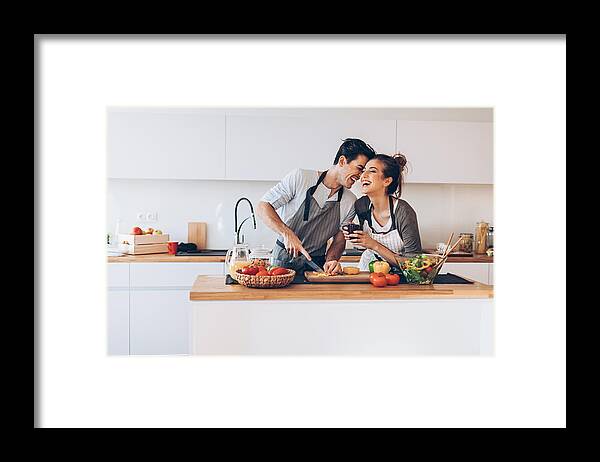 Bulgaria Framed Print featuring the photograph Young couple in love in the kitchen by Pixelfit