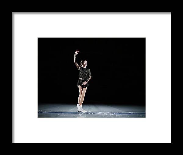 Hand Raised Framed Print featuring the photograph Young Female Figure Skater Finishing by Thomas Barwick