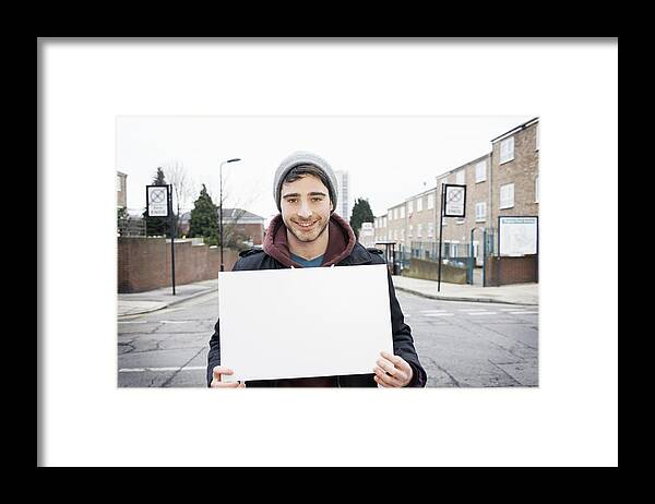 People Framed Print featuring the photograph Young Man Smiling To Camera Holding Blank Sign by Tara Moore