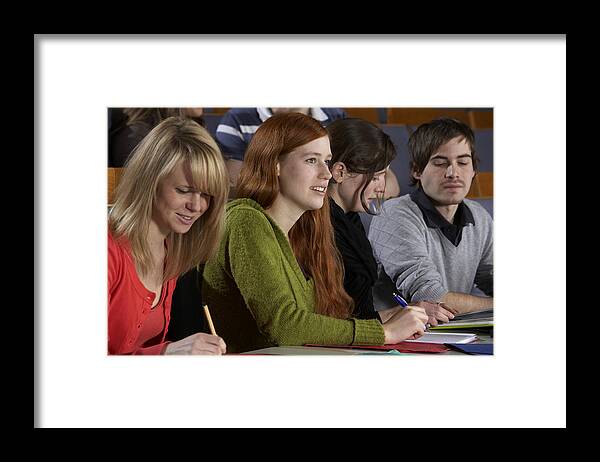 Expertise Framed Print featuring the photograph Young mixed students working and listening during lecture by Clu