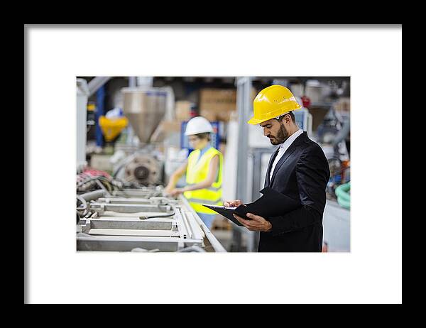 Expertise Framed Print featuring the photograph Young quality inspector checking production line by Milanvirijevic