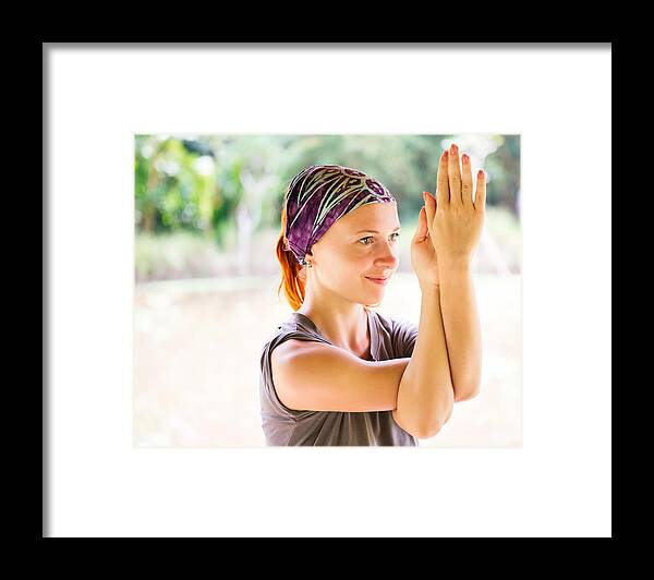 Asia Framed Print featuring the photograph Young woman practicing garudasana by Nikita Buida