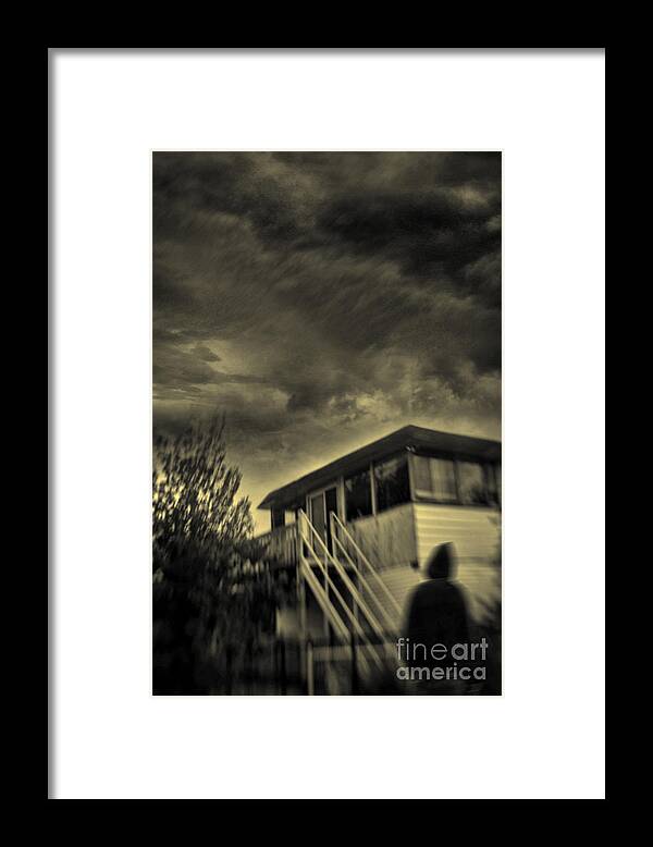 Abandoned Framed Print featuring the photograph Blurred image of hooded figure in front of a derelict building #1 by Sandra Cunningham