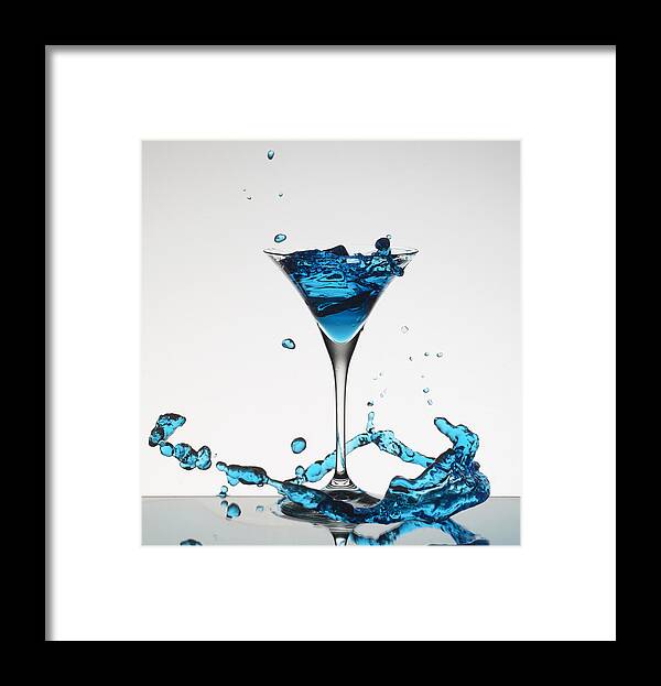Vertical Framed Print featuring the photograph Cocktail Splashing Around Martini Glass #1 by Walter Zerla