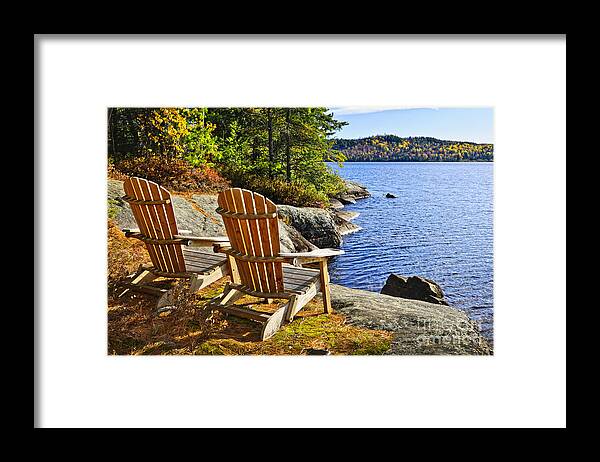 Chairs Framed Print featuring the photograph Adirondack chairs at lake shore 2 by Elena Elisseeva