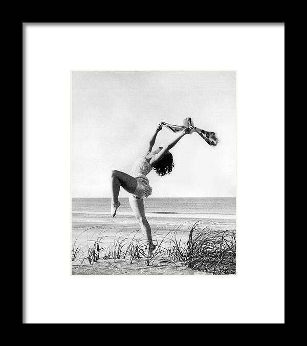 16-20 Years Framed Print featuring the photograph A Woman Dancing On The Shore by Underwood Archives