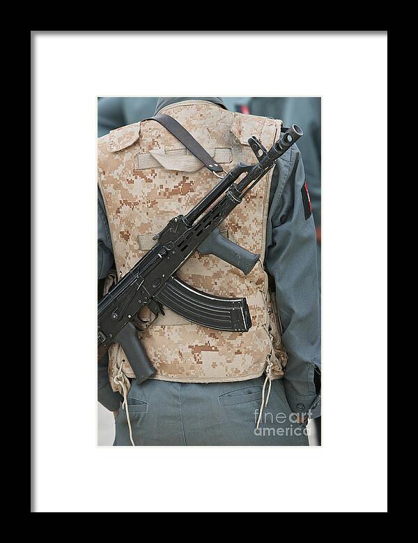 Gun Framed Print featuring the photograph An Ak-47 Rests On The Sling Of An by Terry Moore