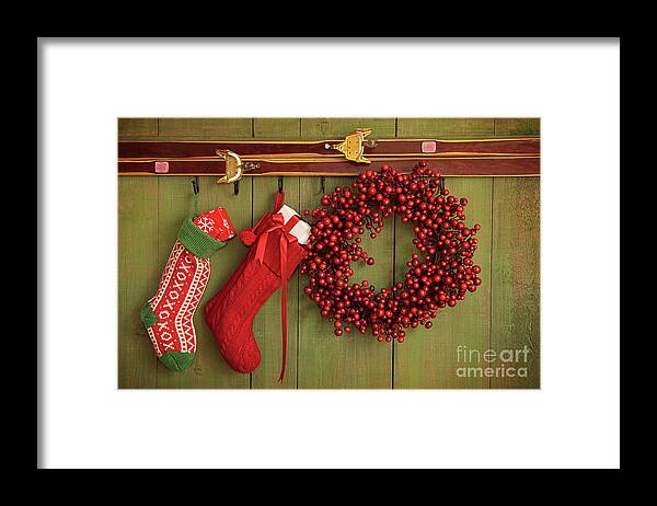 Antique Framed Print featuring the photograph Christmas stockings and wreath hanging on wall by Sandra Cunningham