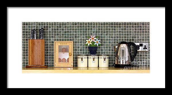 Block Framed Print featuring the photograph Clean kitchen worktop with kitchen items by Simon Bratt