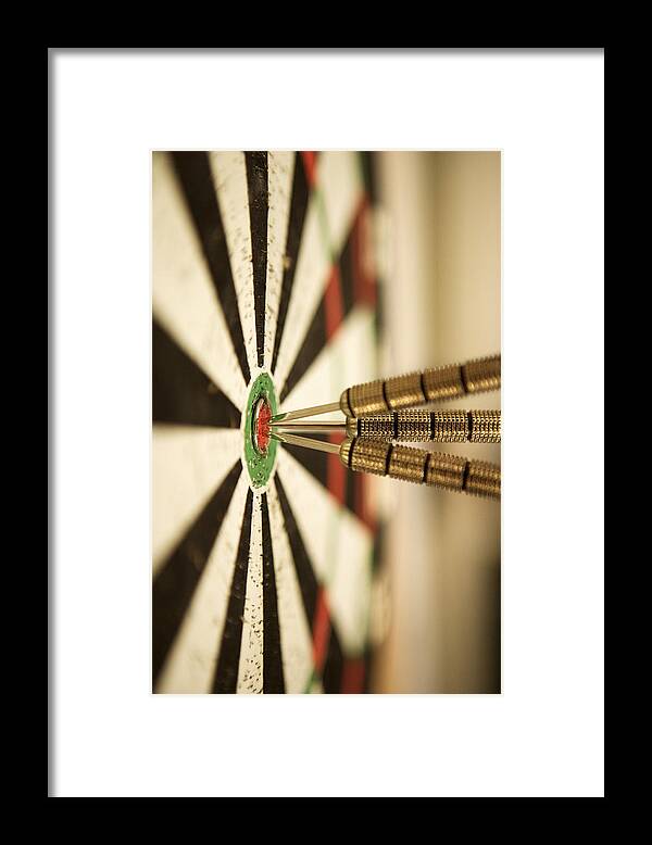 Close-up Framed Print featuring the photograph Darts In Bull's-eye Of Target by Thinkstock
