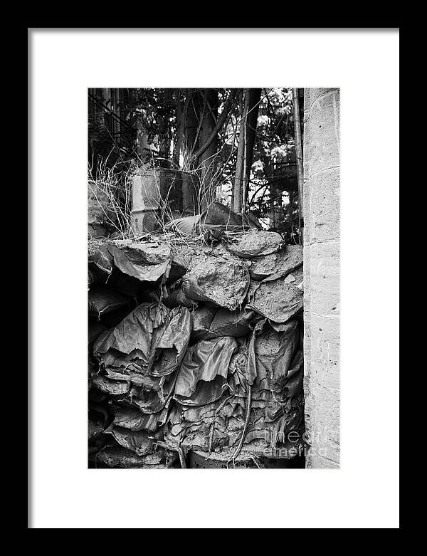 United Framed Print featuring the photograph decaying sandbagged wall from 1974 at UN buffer zone in the green line dividing nicosia cyprus by Joe Fox