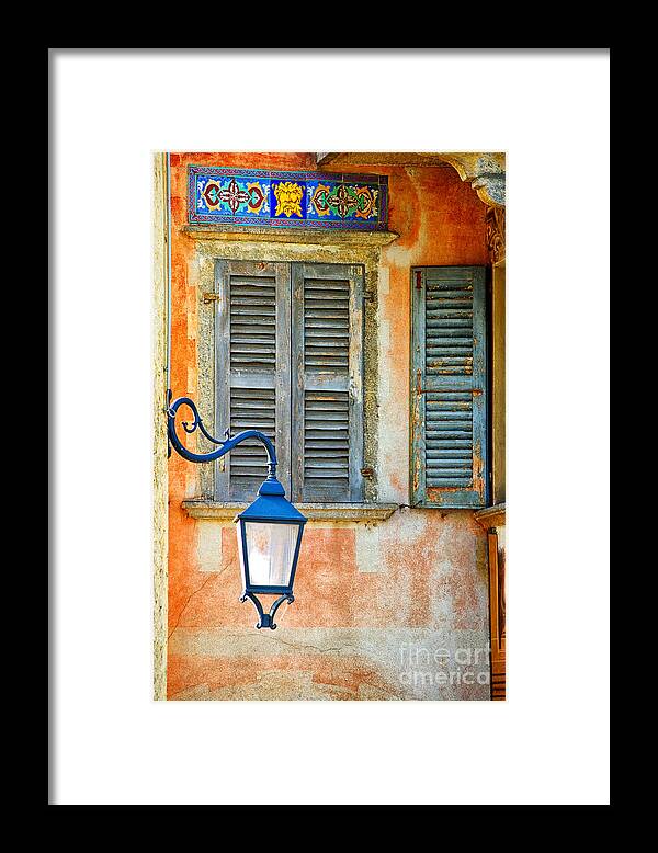 Window Framed Print featuring the photograph Italian street lamp with window and decorated wall by Silvia Ganora