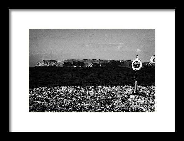 Lifebelt Framed Print featuring the photograph Lifebelt On Rocks At Ballintoy With Moyle Sea And Rathlin Island by Joe Fox