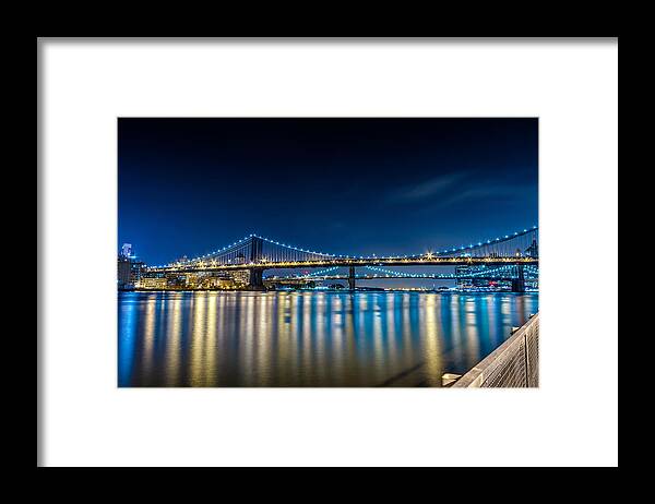 Downtown Framed Print featuring the photograph Manhattan Bridge and light reflections in East River. by Val Black Russian Tourchin