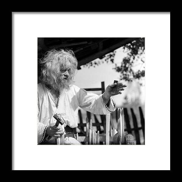 Accuracy Framed Print featuring the photograph Old man working on the wooden car by Emanuel Tanjala