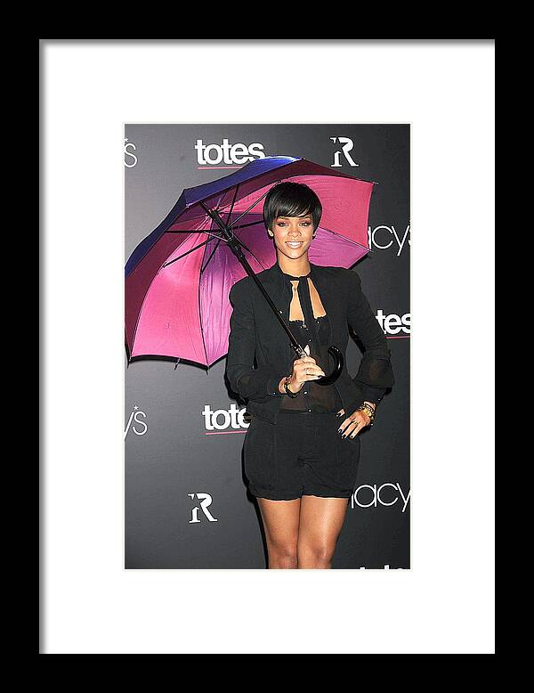 Rihanna Umbrella Collection Launch By Totes And Macy''s Framed Print featuring the photograph Rihanna Wearing Matthew Williamson by Everett