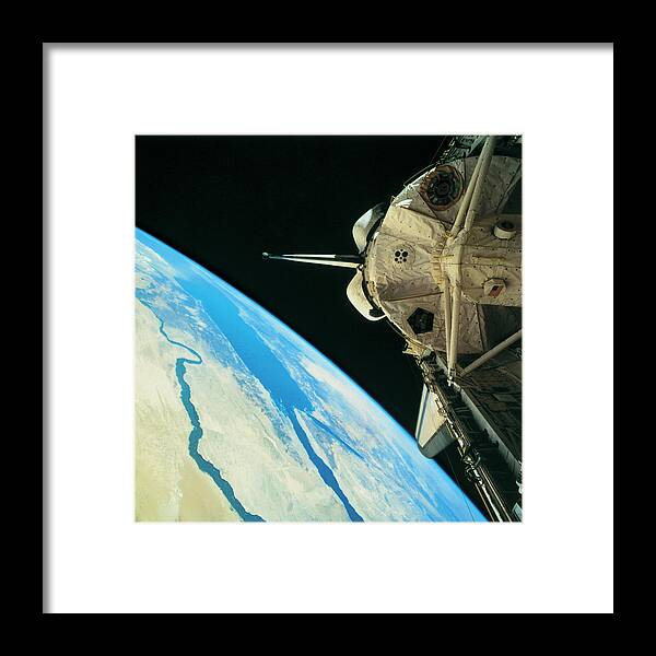 Vertical Framed Print featuring the photograph Space Shuttle Orbiting The Earth by Stockbyte