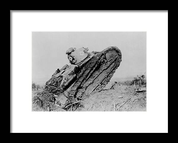 \world War I\ Framed Print featuring the photograph Tank ploughing its way through a trench and starting toward the German line during World War I by International Images