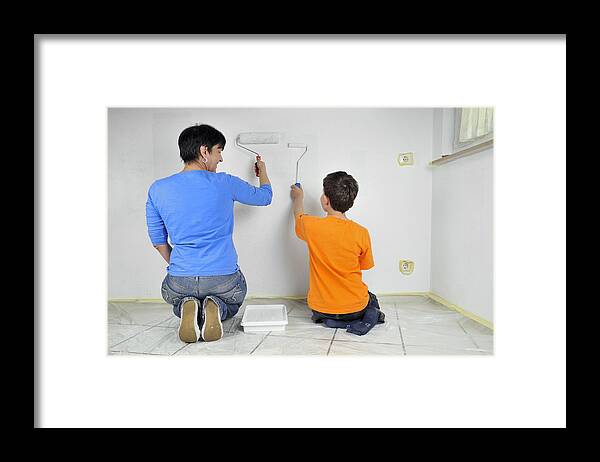 Teamwork Framed Print featuring the photograph Teamwork - Mother and child painting wall by Matthias Hauser