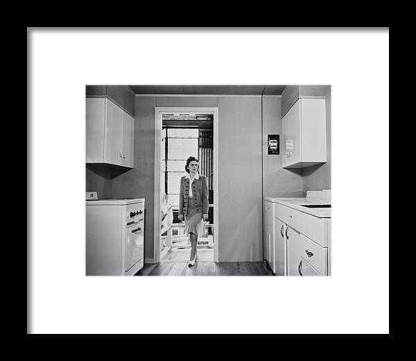 Women Enters A Modern 1940s Kitchen Framed Print