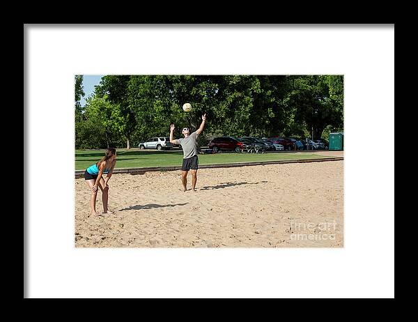 Beach Framed Print featuring the photograph A young male athlete serving and playing volleyball on Zilker Park sand volleyball courts #1 by Dan Herron