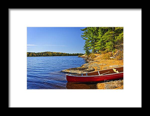 Canoe Framed Print featuring the photograph Canoe on shore 2 by Elena Elisseeva