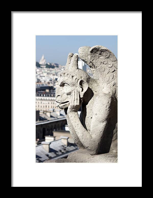 Gargoyle Framed Print featuring the photograph Gargoyle guarding the Notre Dame Basilica in Paris #1 by Pierre Leclerc Photography