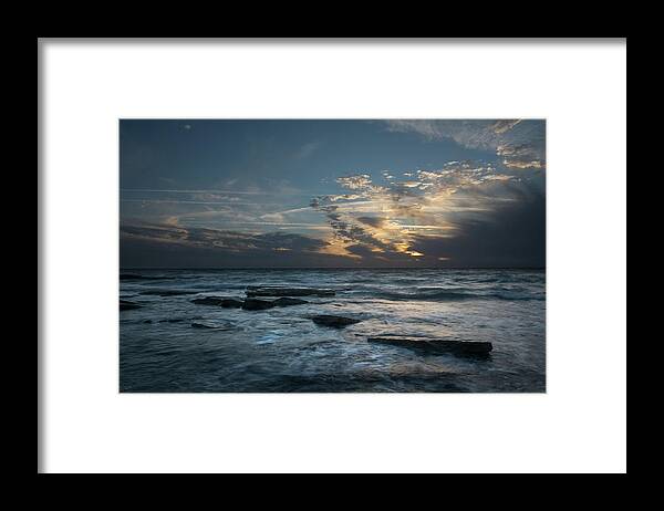 Sunset Over Sea Framed Print featuring the photograph Sunset on a rocky beach by Michalakis Ppalis