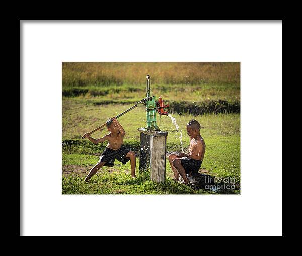 Sun Framed Print featuring the photograph Two young boy rocking groundwater bathe in the hot days. #1 by Tosporn Preede