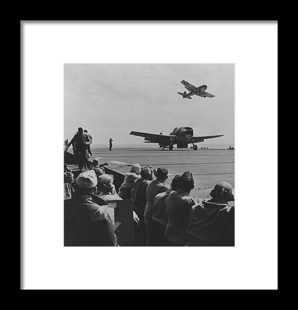 Plane Framed Print featuring the photograph A US Navy Hellcat Fighter Aircraft Landing On The Deck Of A Carrier by American School