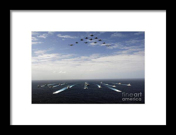 Horizontal Framed Print featuring the photograph Aircraft Fly Over A Group Of U.s by Stocktrek Images