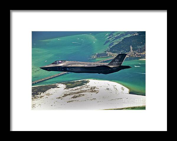 Stealth Framed Print featuring the photograph An F-35 Lightning II Flies Over Destin by Stocktrek Images