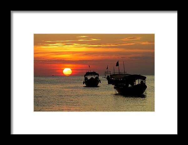 Sunset Framed Print featuring the photograph As the sun meets the sea by David Freuthal