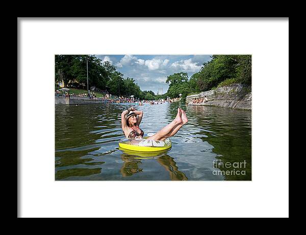 Barton Springs Pool Framed Print featuring the photograph Attractive Austin local enjoys the warm sun rays and cool waters by Dan Herron