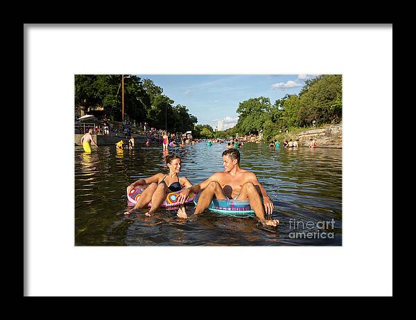 Barton Springs Pool Framed Print featuring the photograph Attractive smiling couple floating on inner tube at Barton Sprin by Dan Herron