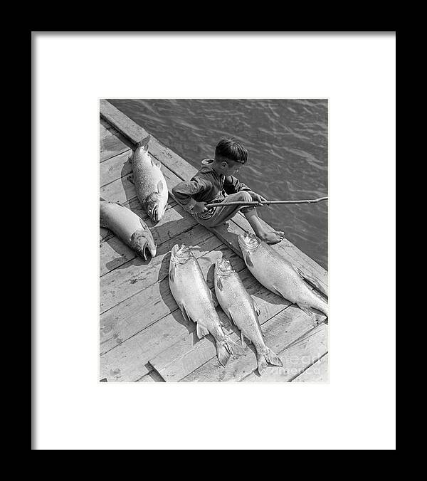 1930s Framed Print featuring the photograph Boy On Dock With Caught Fish by H. Armstrong Roberts/ClassicStock