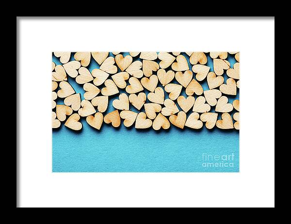 Love Framed Print featuring the photograph Bunch of hearts on blue background. by Michal Bednarek