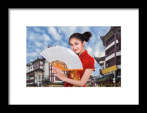 Shanghai Framed Print featuring the photograph Chiness lady in cheongsam dress with Shanghai vintage building a by Anek Suwannaphoom