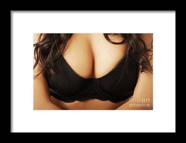 Close up on female boobs in black bra Framed Print